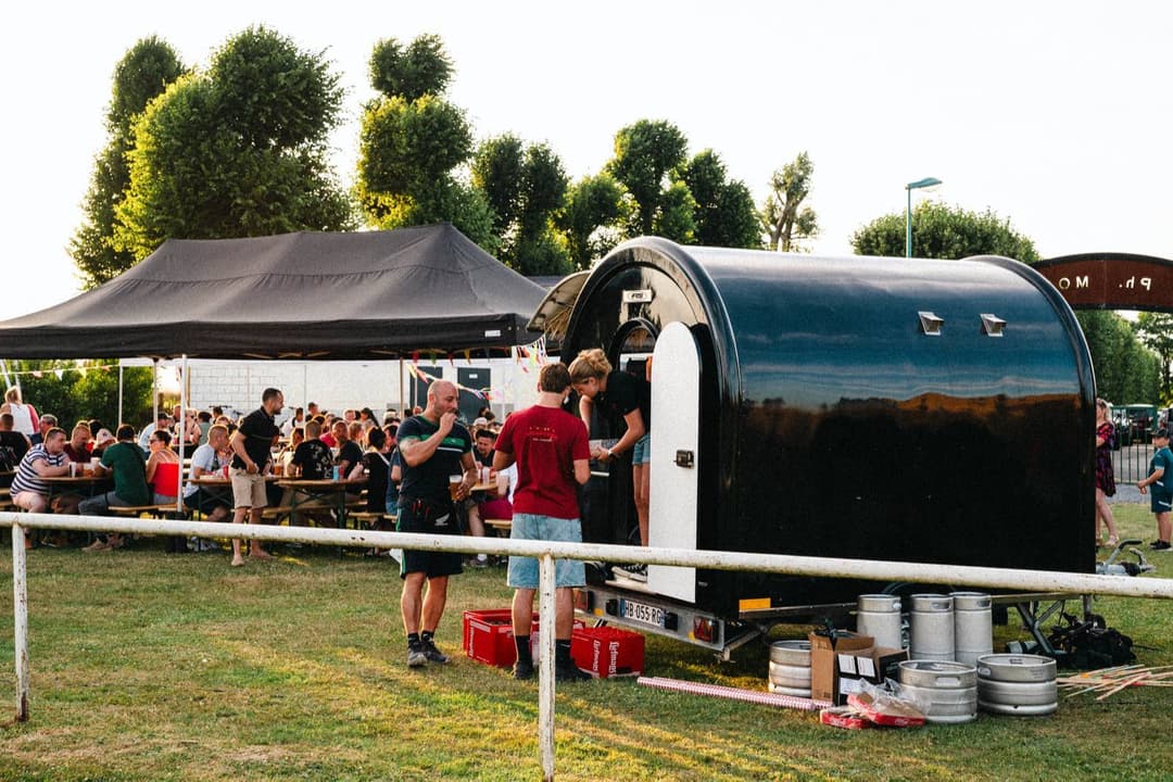 Foodtruck op een avondevenement, met gasten voor de foodtrailer